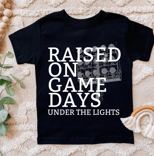 Raised On Game Days Under The Lights Kids T-Shirt