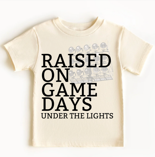 Raised On Game Days Under The Lights Kids T-Shirt
